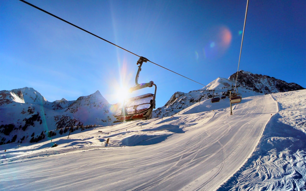 lift view towards rising sun in winter ski resort scenery